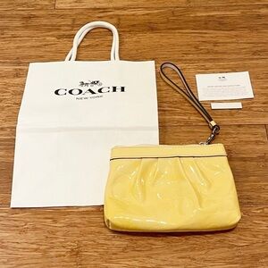 COACH bright yellow patent leather logo wristlet clutch purse. Size 6.5" X 4.5"